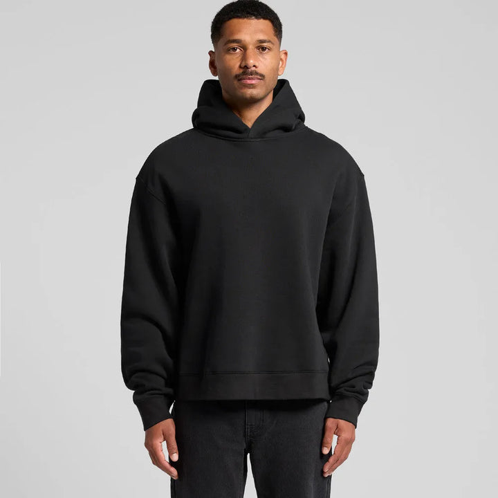 Man wearing boxy fit black hoodie with relaxed oversized silhouette