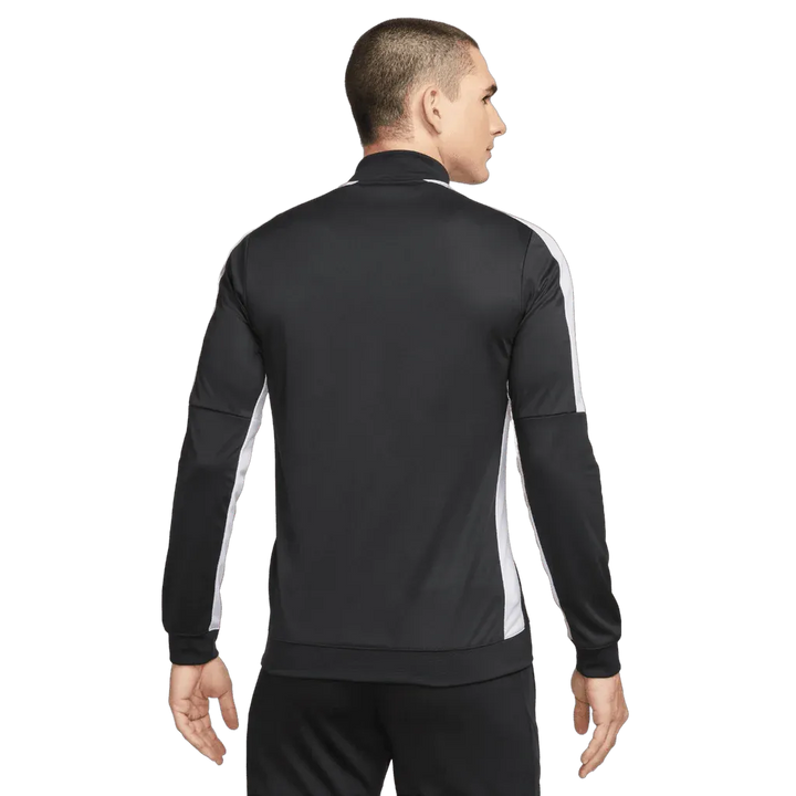 Person wearing a black and white tracksuit on a white background