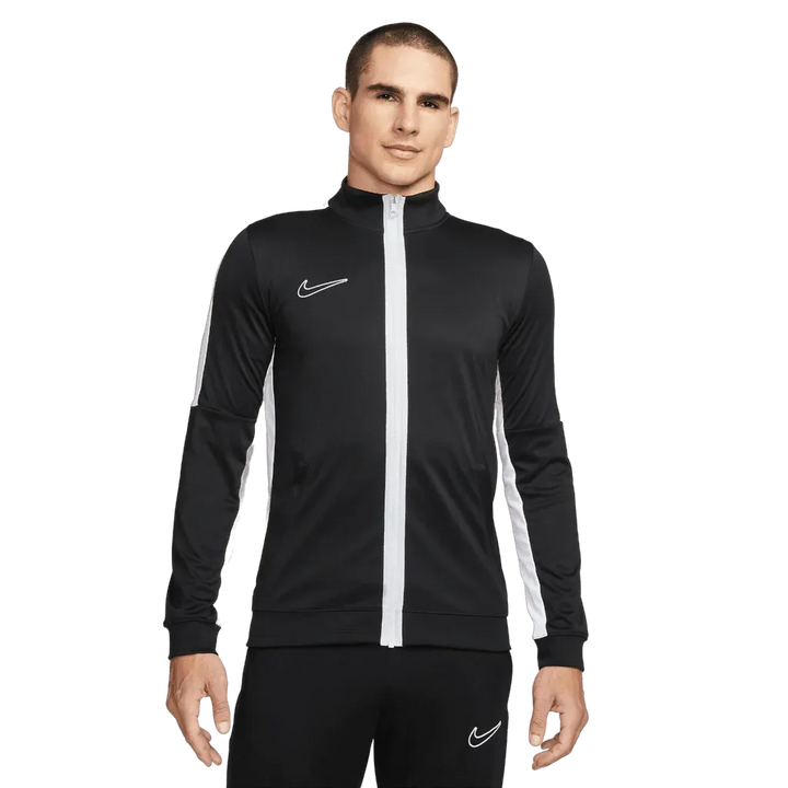 Man wearing a black and white Nike tracksuit on a white background