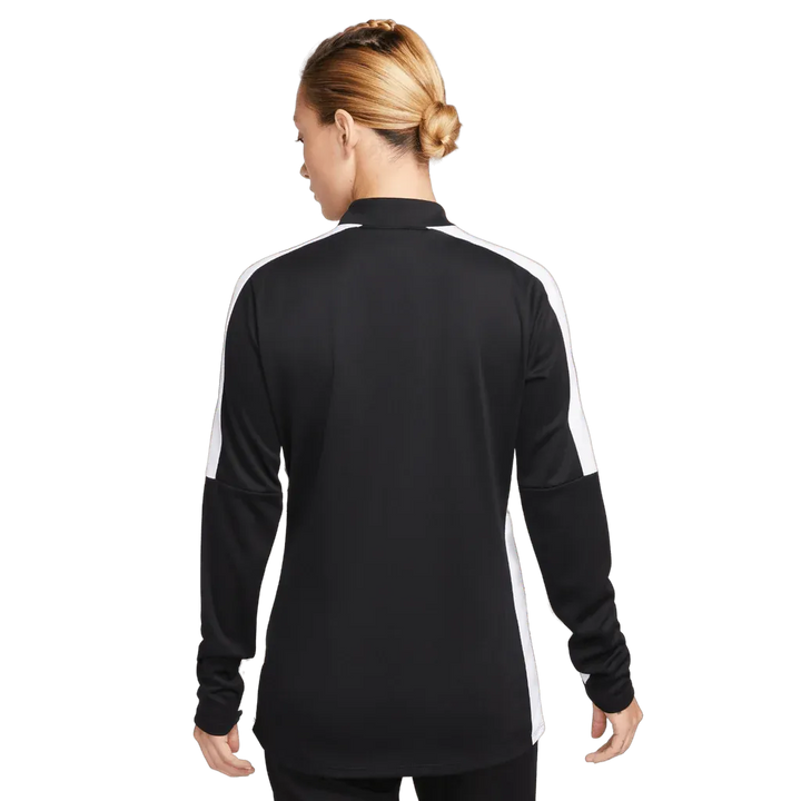 Rear view of woman wearing Nike black and white Academy Pro Jacket, full-length studio shot