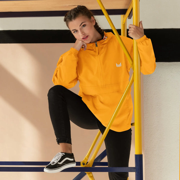 Woman in yellow windbreaker sitting on outdoor bars in urban style