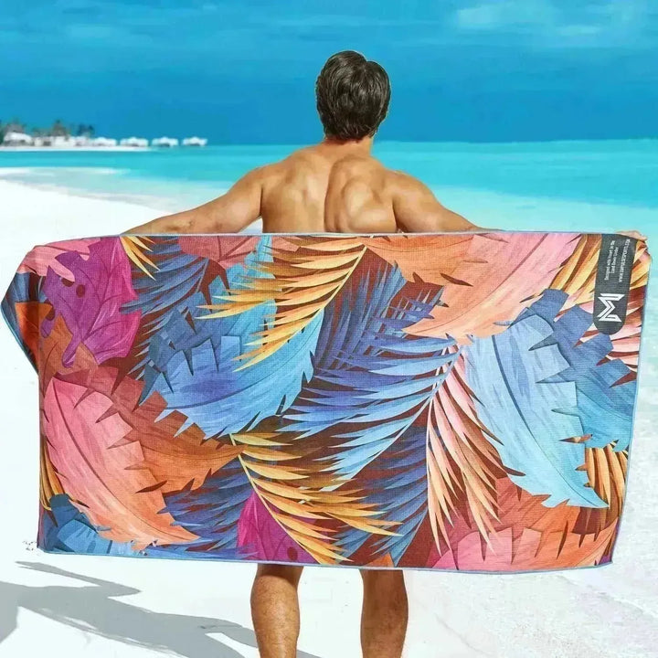 Flatlay of Vibrant Canopy towel showing reverse-side geometric orange pattern