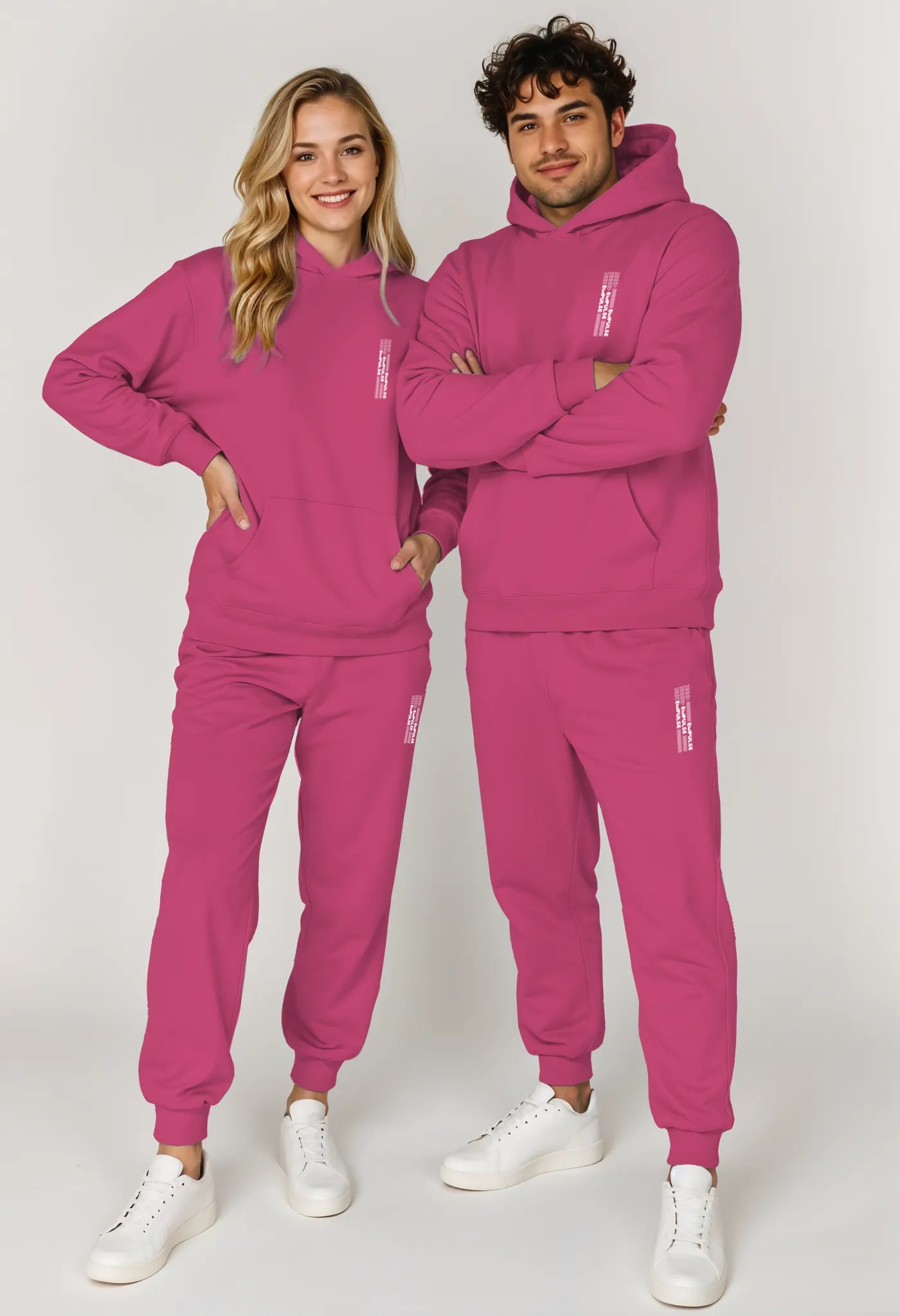 Couple wearing matching Empulse™ pink hoodies and joggers with minimalist logo

