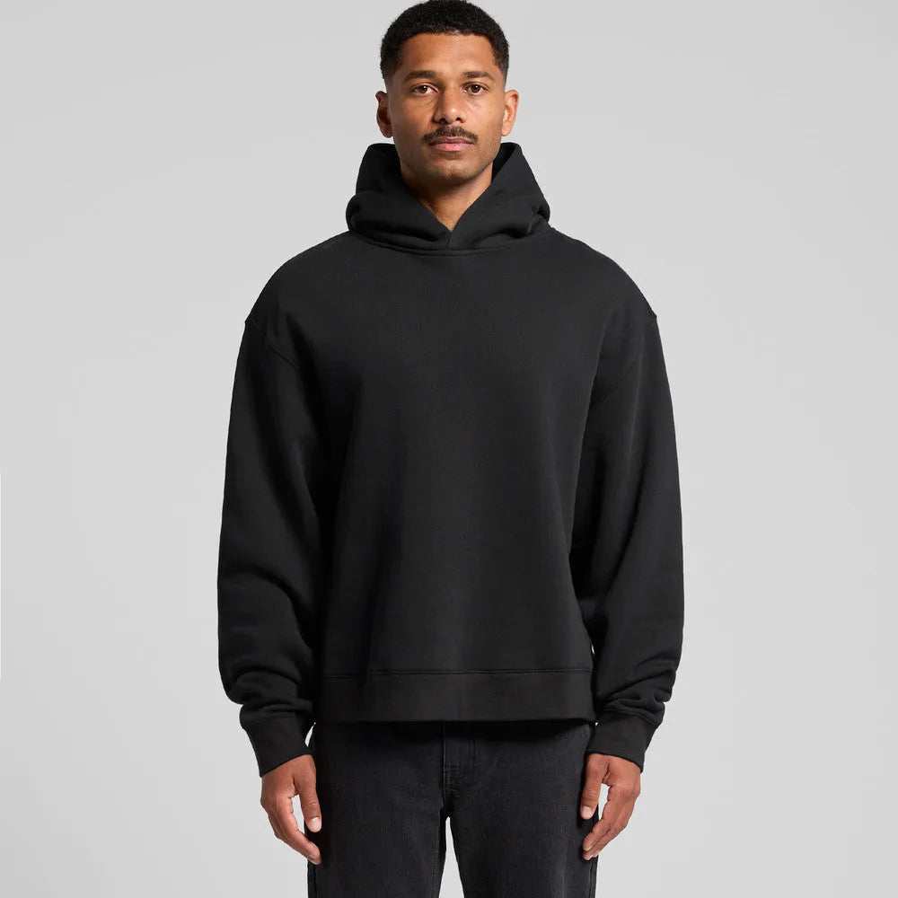 Man wearing boxy fit black hoodie with relaxed oversized silhouette