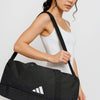 Woman wearing white dress holding black Adidas duffel bag with shoulder strap