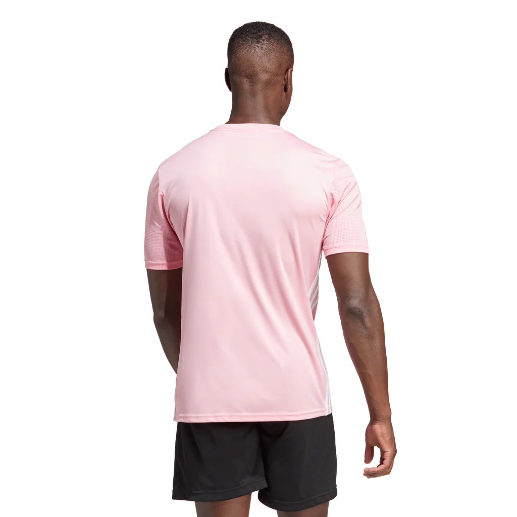 Person wearing a pink sports jersey and black shorts on a white background