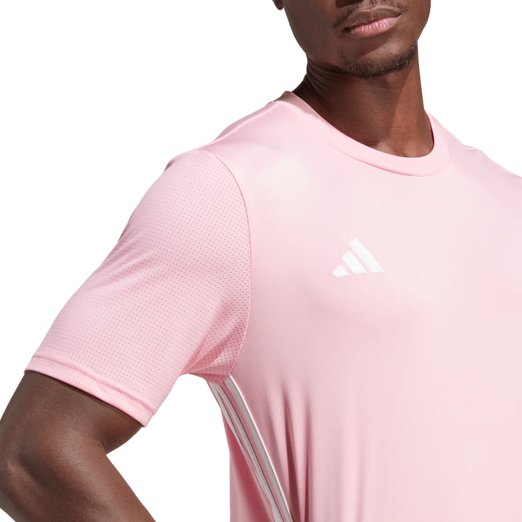 Person wearing a pink Adidas sports shirt with a white background