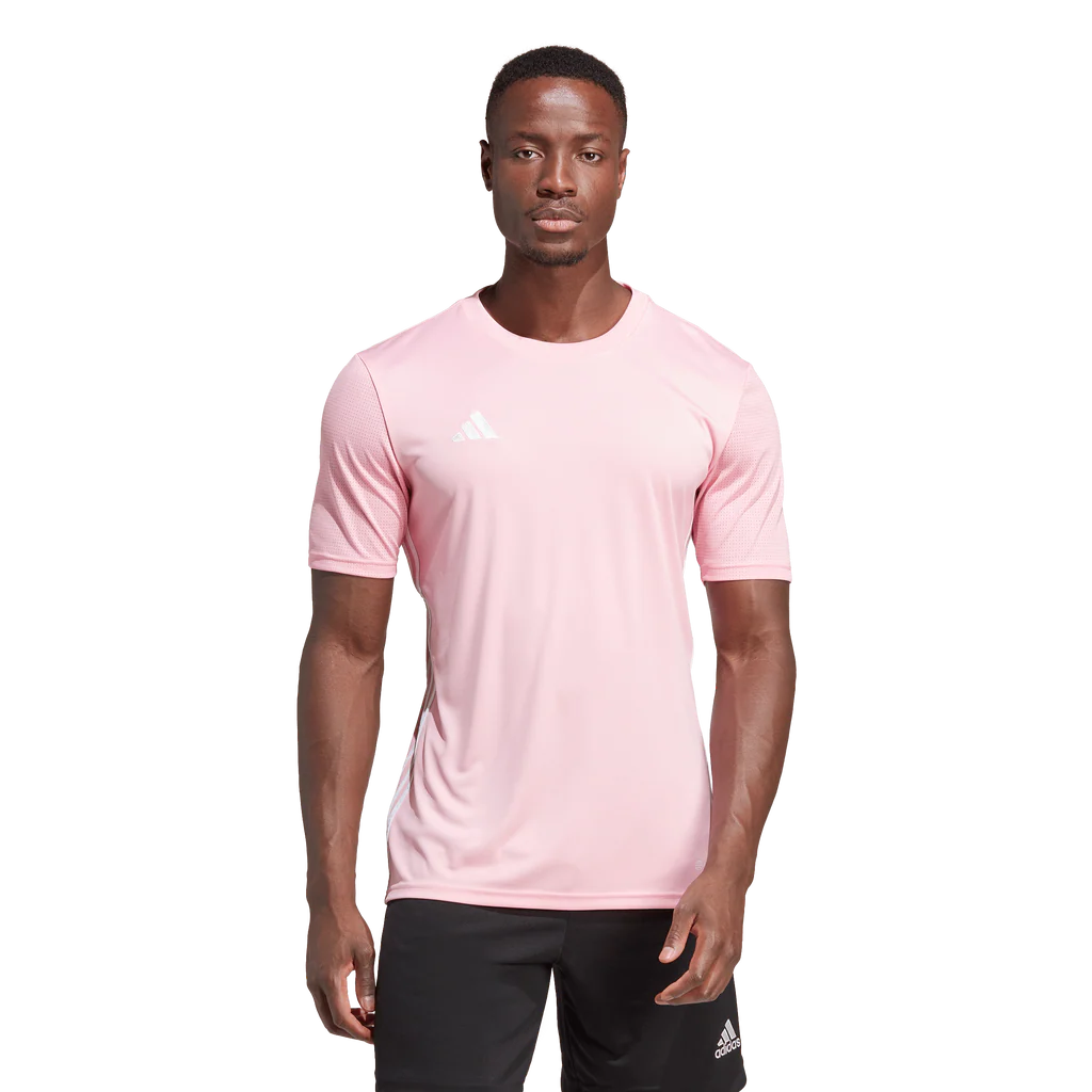 Person wearing a pink Adidas t-shirt on a white background