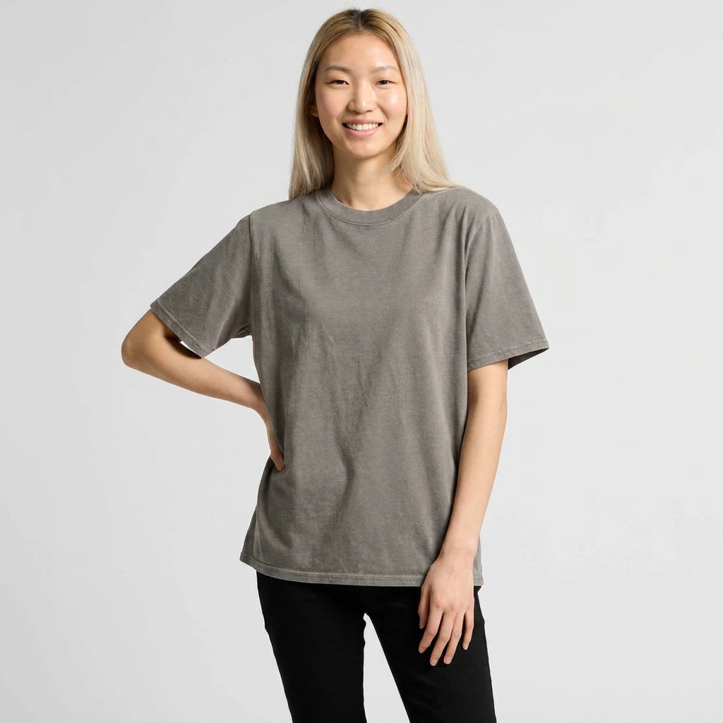 Woman wearing a gray t-shirt against a plain background