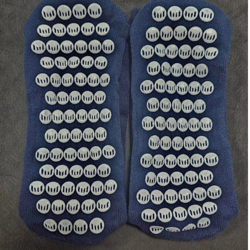 El Toro Navy socks with white textured dots on a gray background