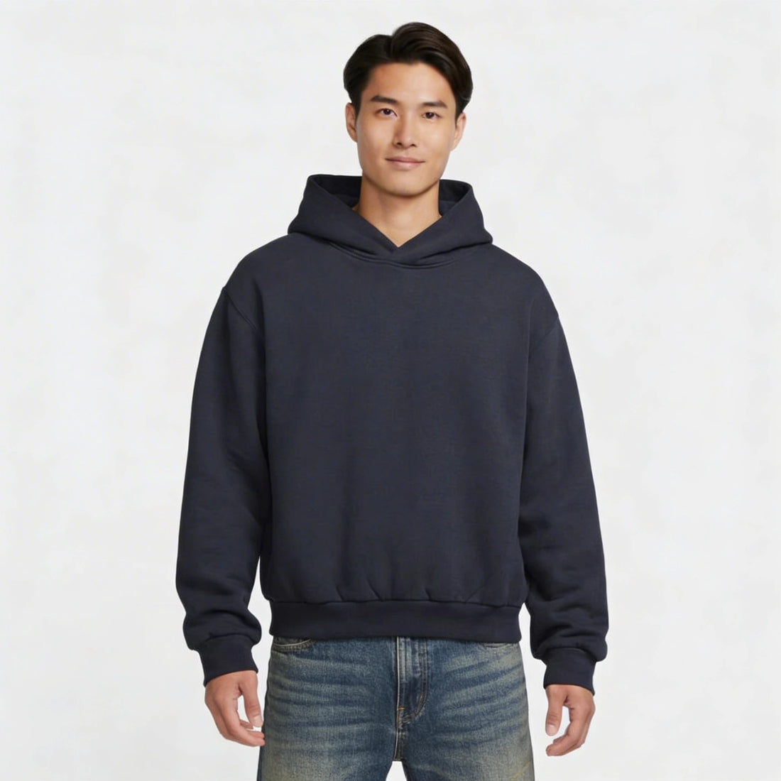 Man wearing a navy blue hoodie on a white background