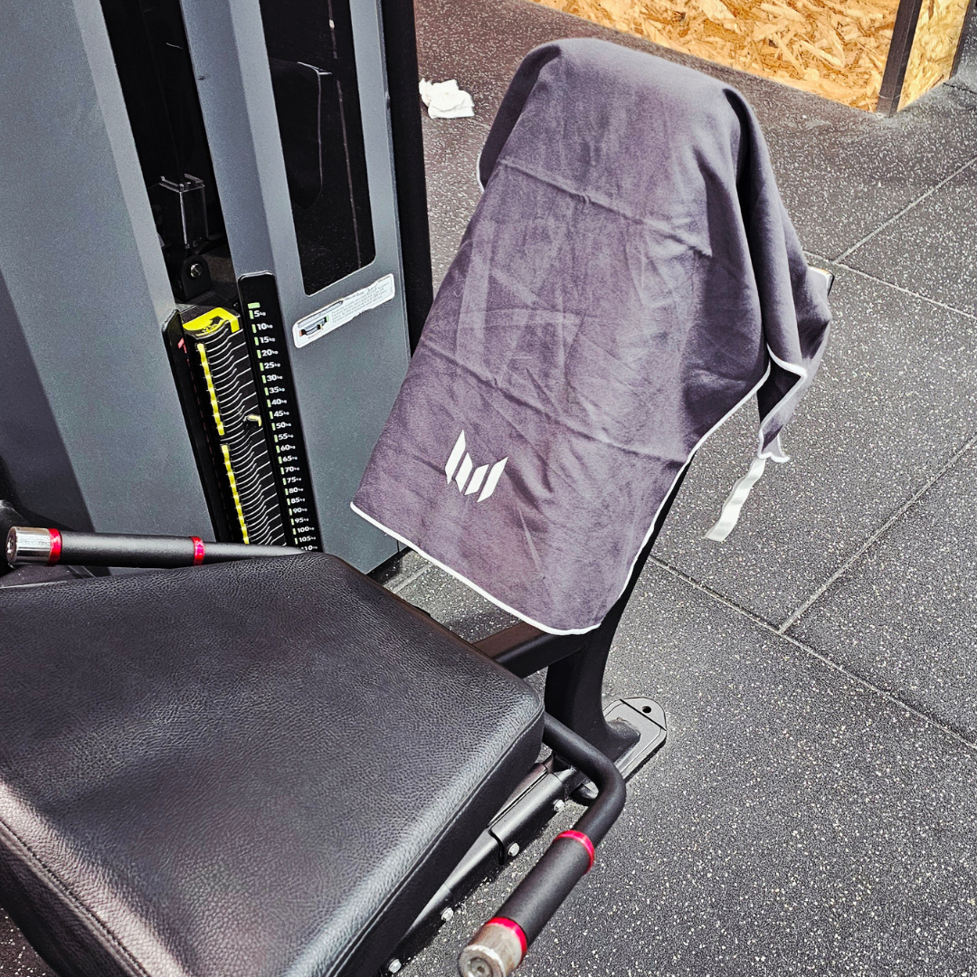Gray towel draped over a gym machine with a visible brand logo.