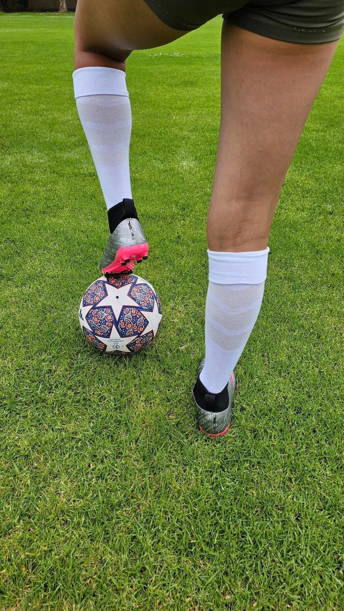 A female model wearing Empulse knee high compression socks in white