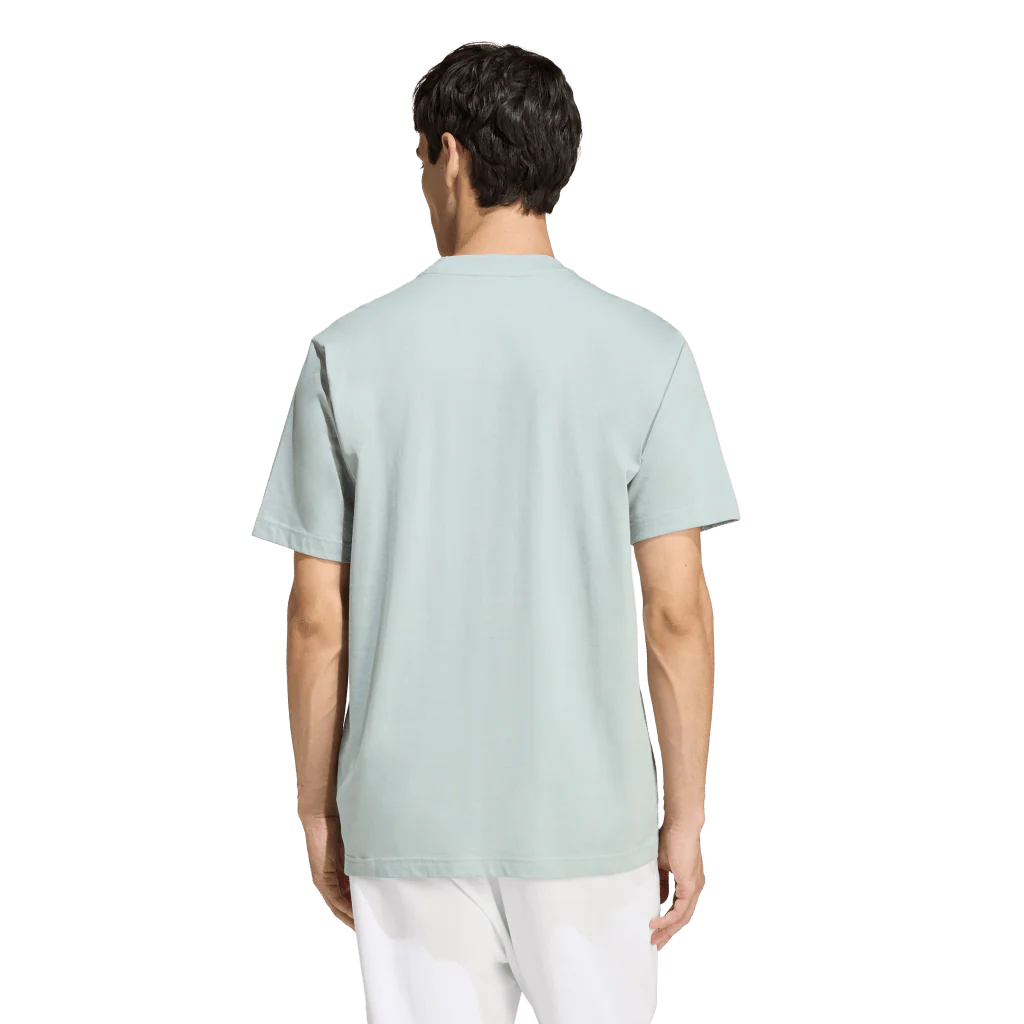 Person wearing a light green t-shirt on a white background
