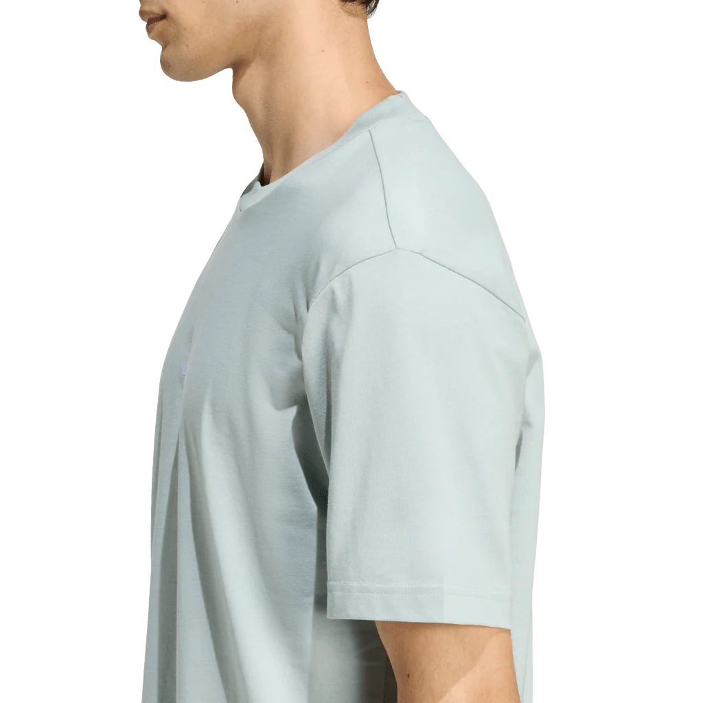 Person wearing a light gray t-shirt on a white background