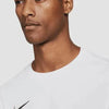 Male model wearing white Nike Dri-FIT Park VII long sleeve shirt, Swoosh logo close-up