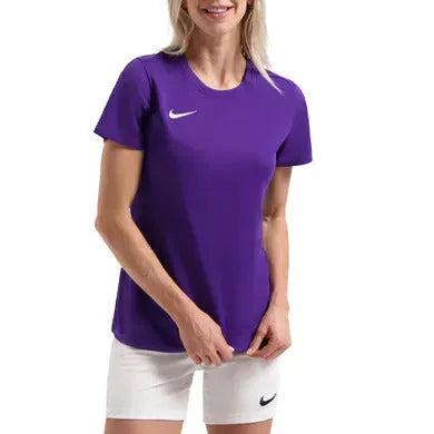 Person wearing a purple Nike t-shirt and white shorts on a white background