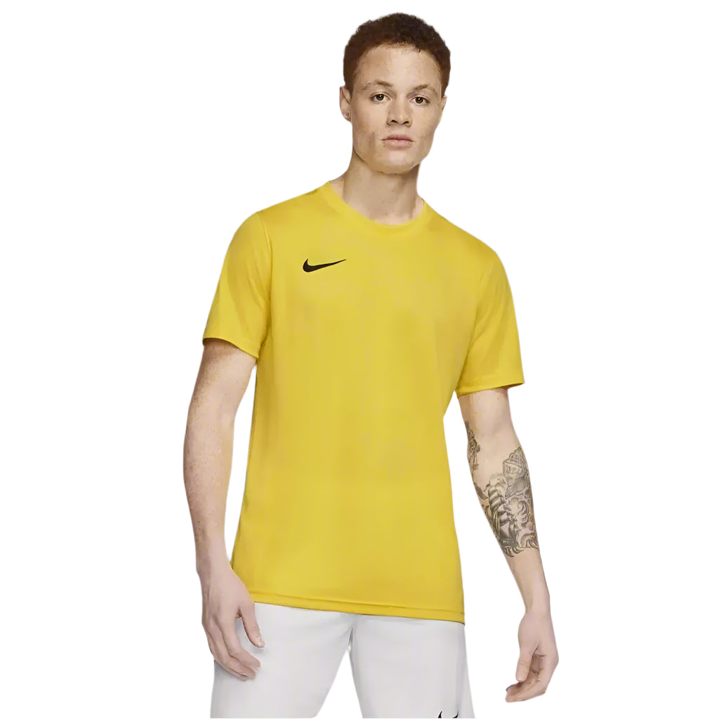 Full body view of male model wearing yellow Nike Park 7 Jersey with white shorts and shoes