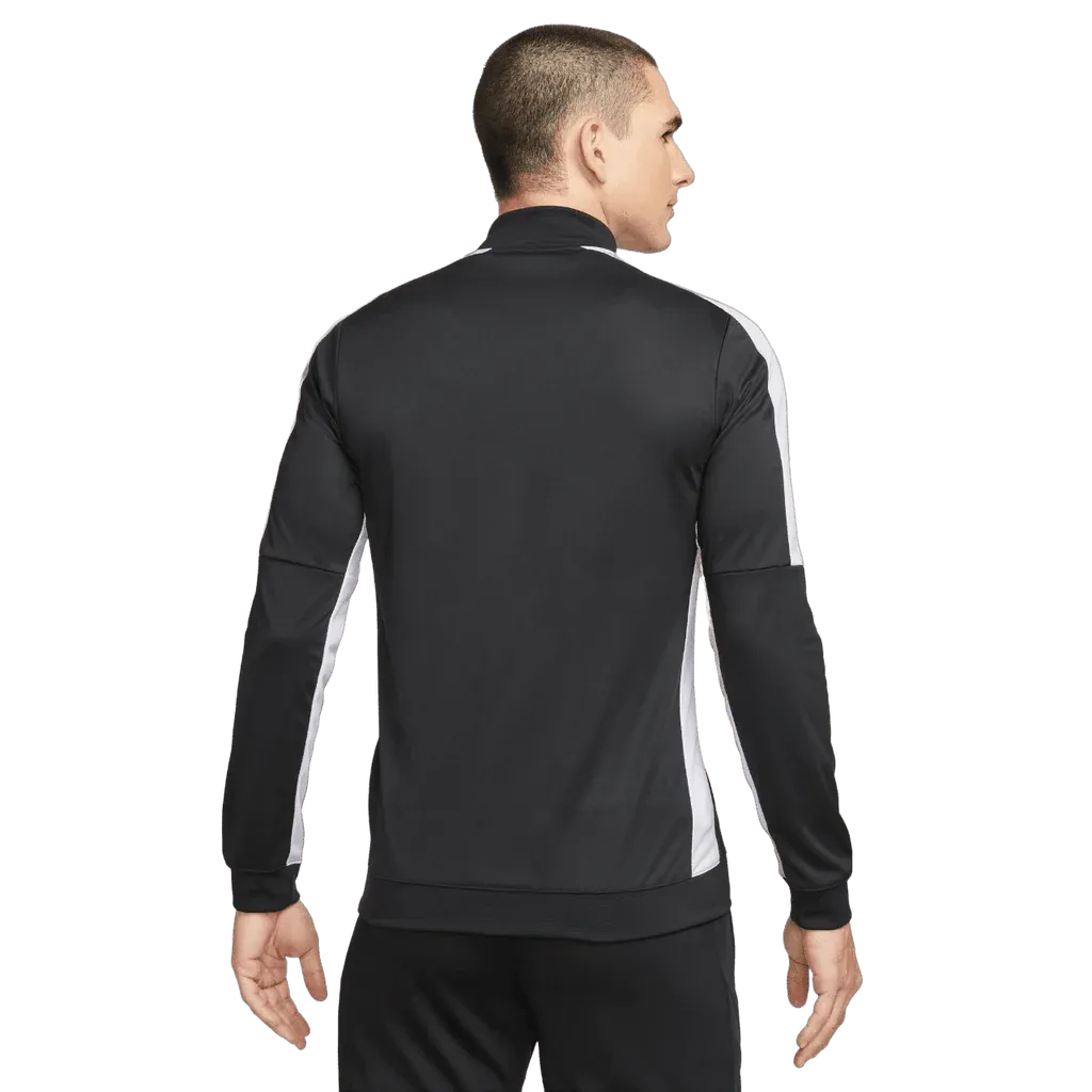 Person wearing a black and white tracksuit on a white background