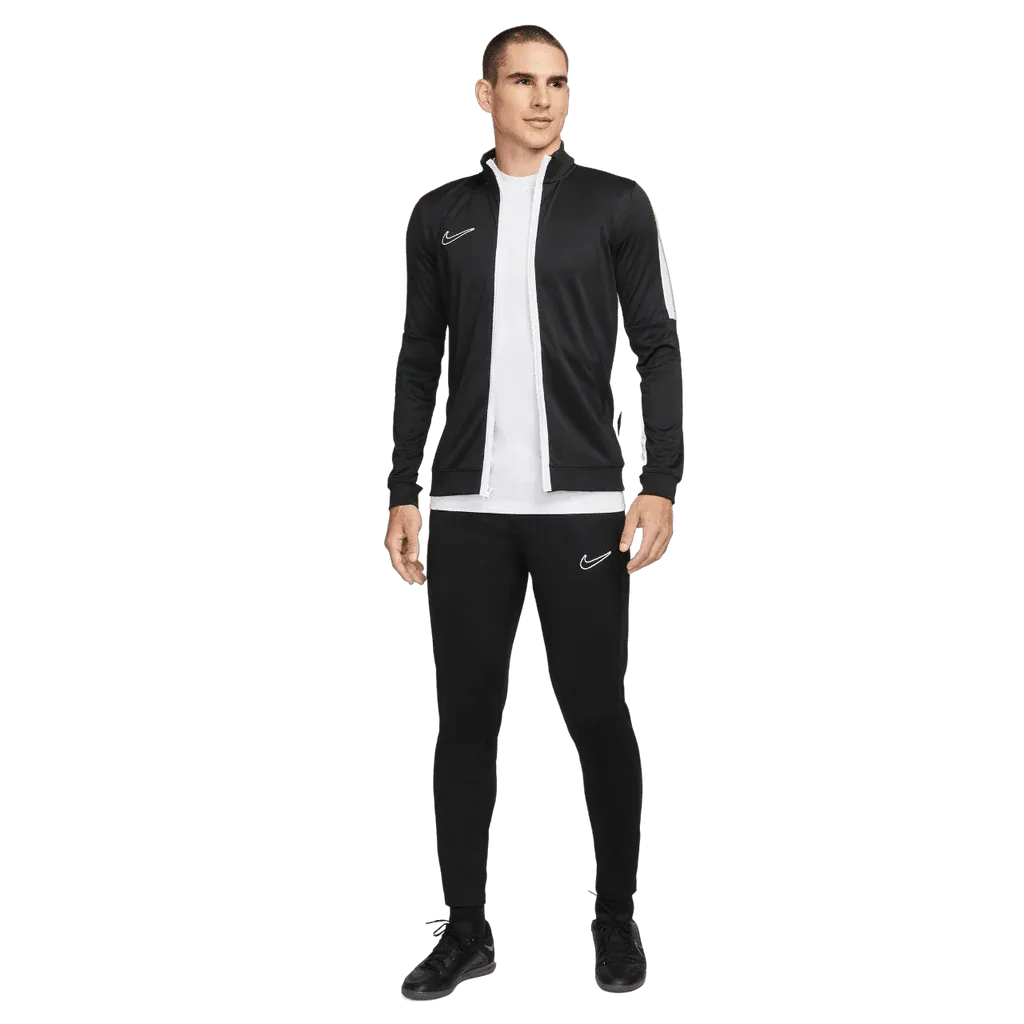 Man wearing a black Nike tracksuit on a white background