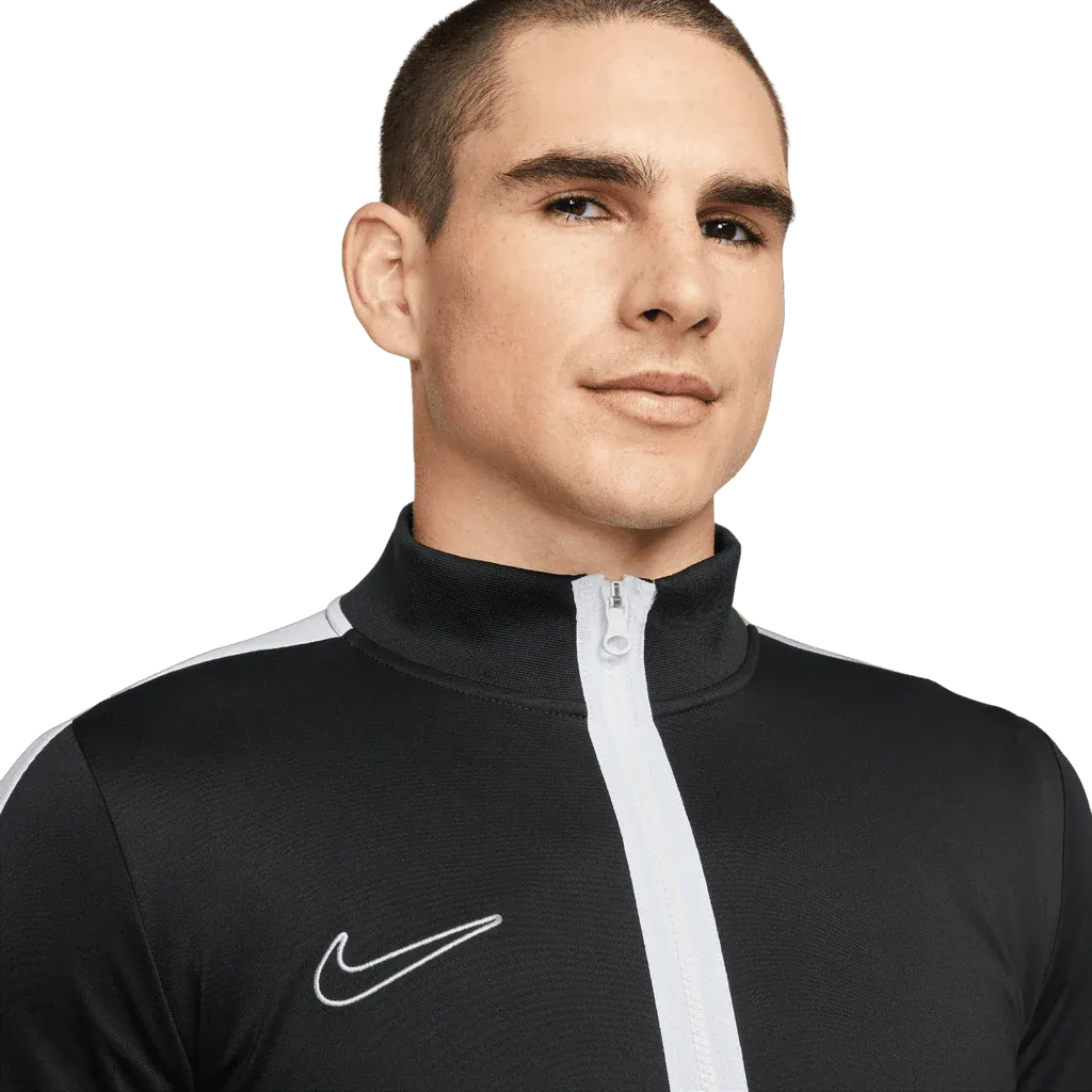 Man wearing a black Nike tracksuit on a white background