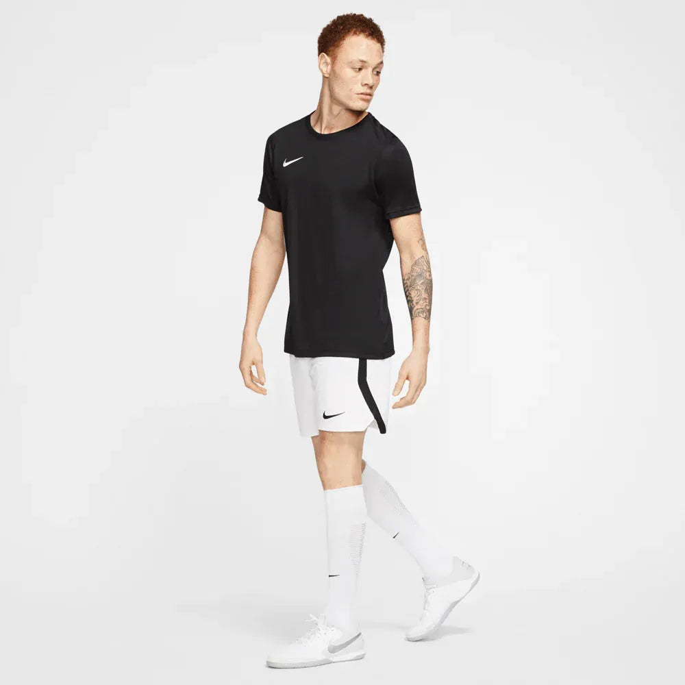 Full-body image of male model wearing black Nike Park 7 Jersey with white shorts and socks