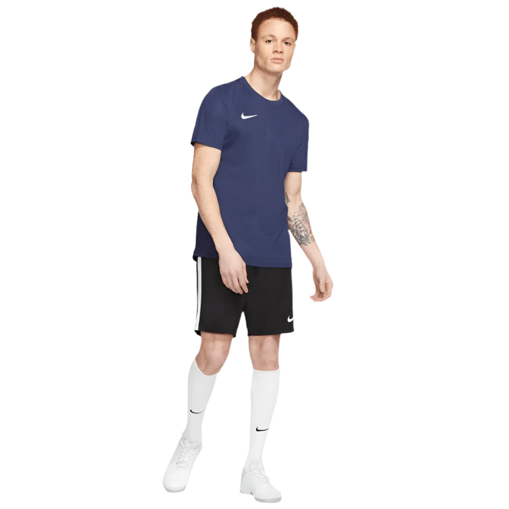 Full body view of model in navy Nike Park 7 Jersey paired with black shorts and white socks