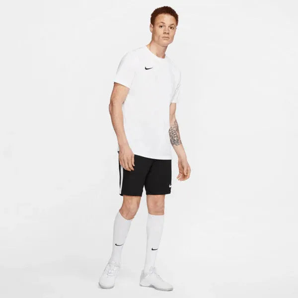 Full body view of model in Nike Park 7 Jersey in white with black shorts and white socks