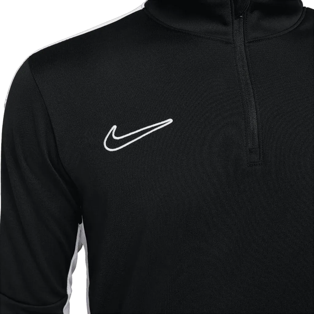 Close-up of white embroidered Nike Swoosh on the chest of black Academy Pro Jacket
