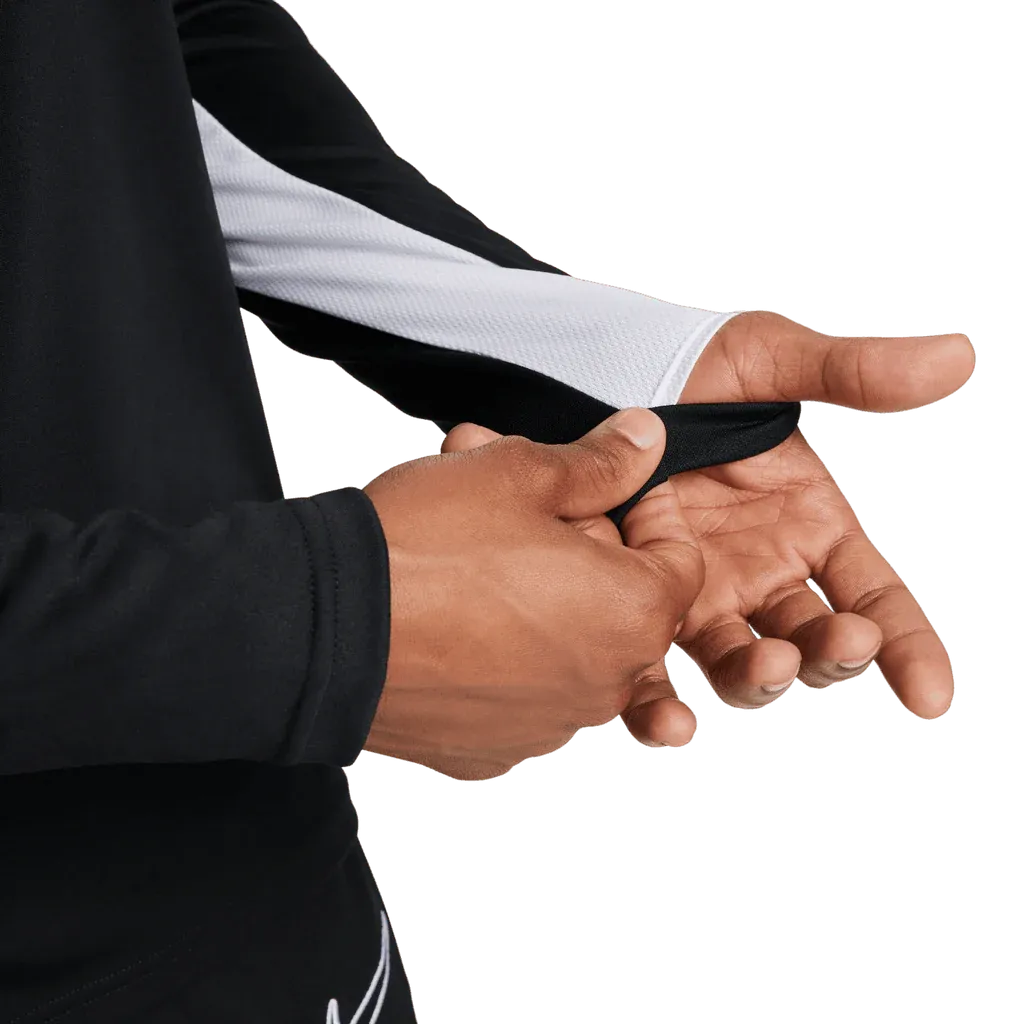 Close-up of cuff detail and hand placement in Nike Academy Pro black training jacket