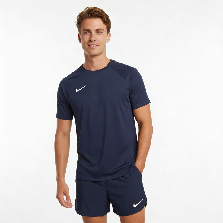 Man wearing navy athletic outfit with Nike logo on a white background
