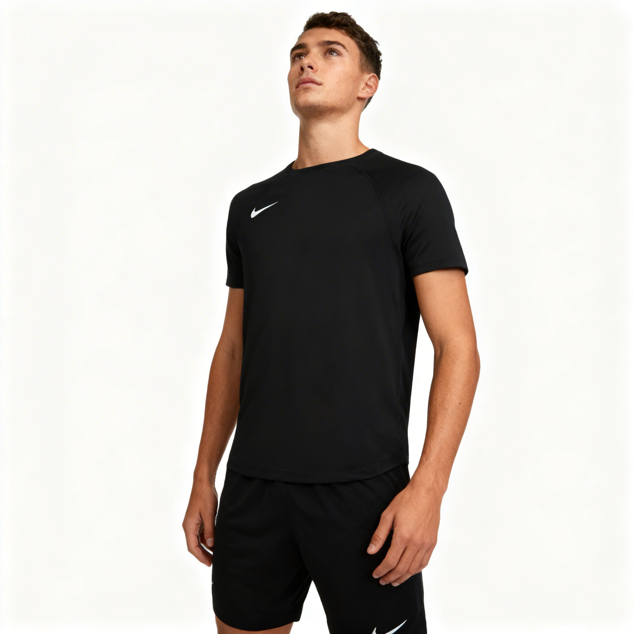 Man wearing a black Nike athletic outfit on a white background