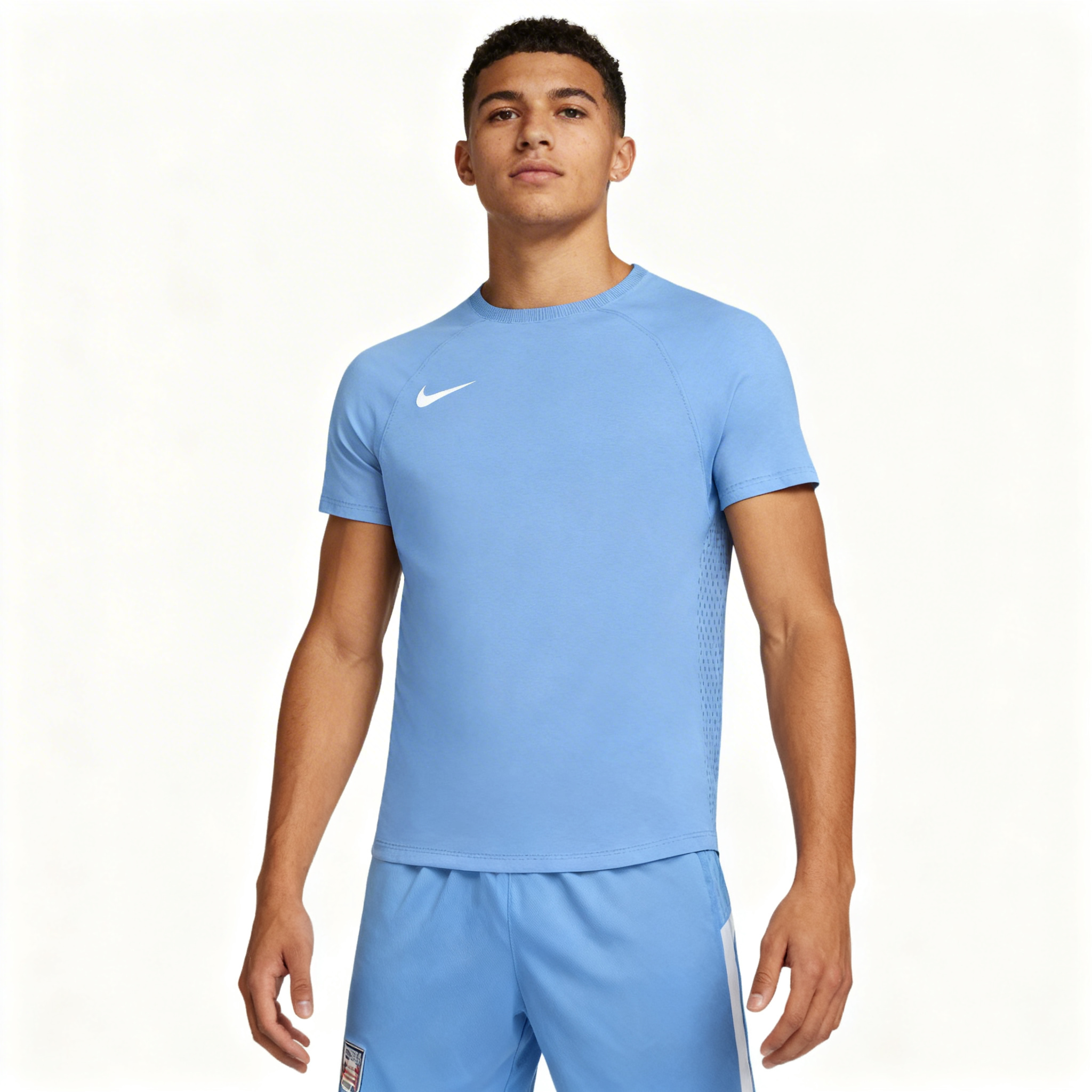 Person wearing a blue Nike athletic outfit on a white background