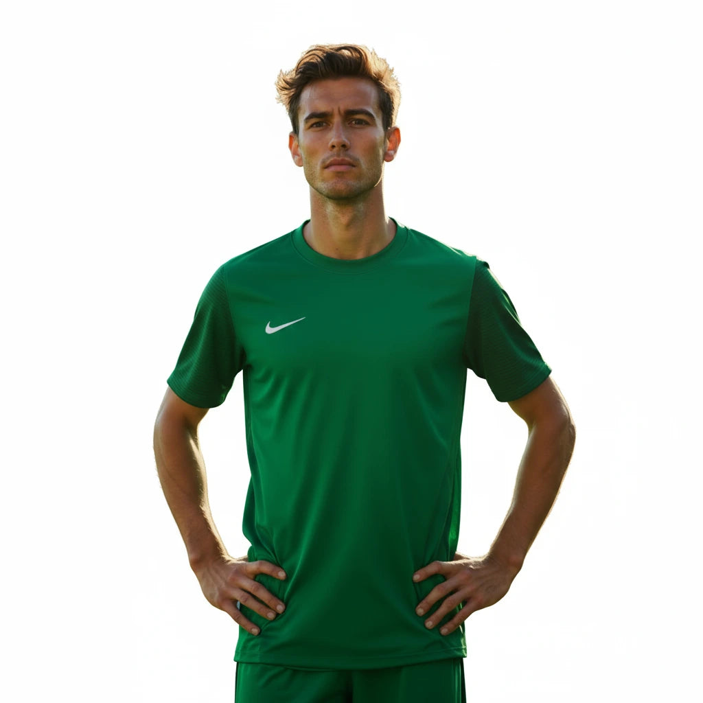 Man wearing a green Nike sports outfit on a white background
