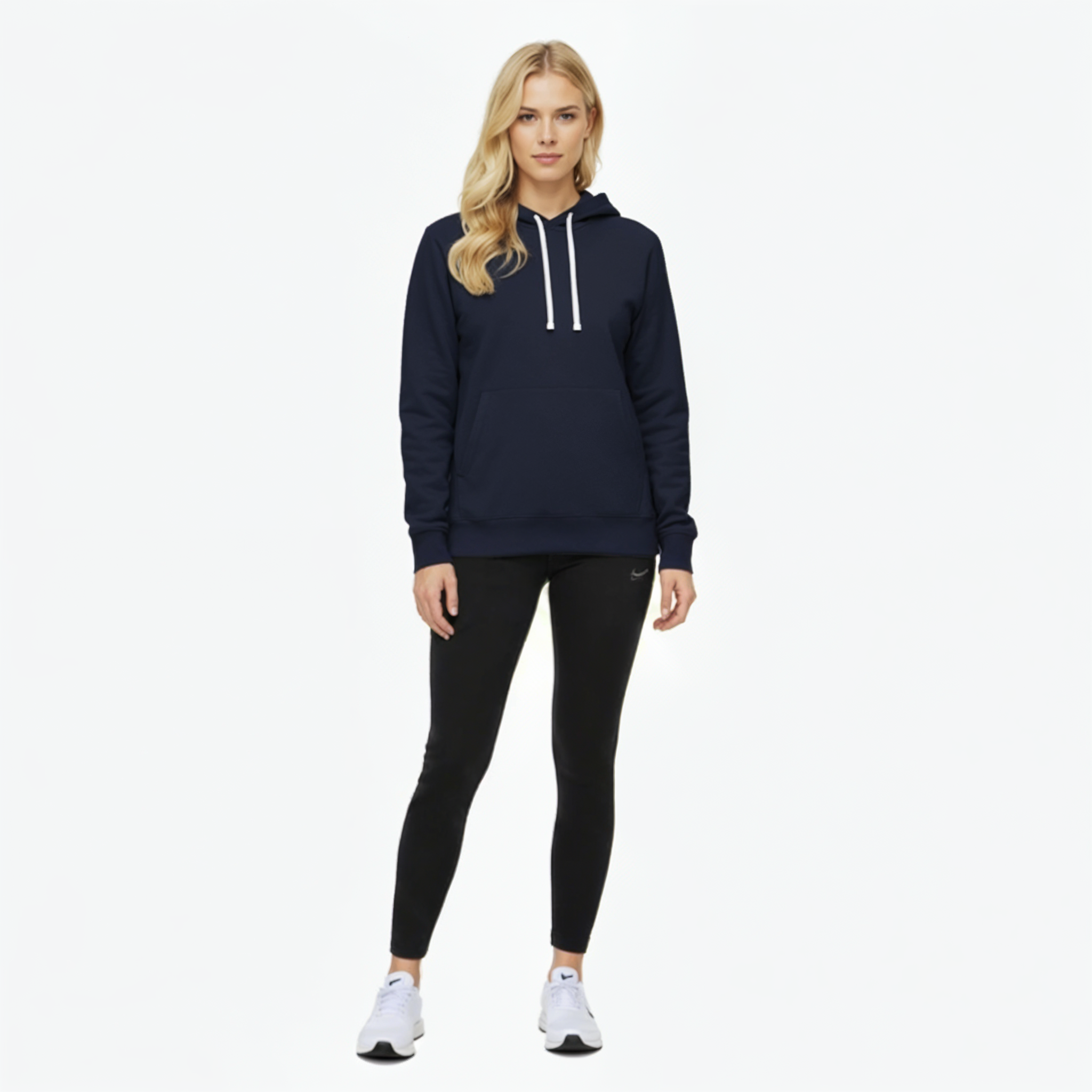 Woman wearing a navy Nike Park 20 hoodie and black leggings on a white background