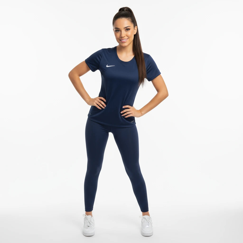 Woman wearing a navy blue athletic outfit with a Nike logo on a white background