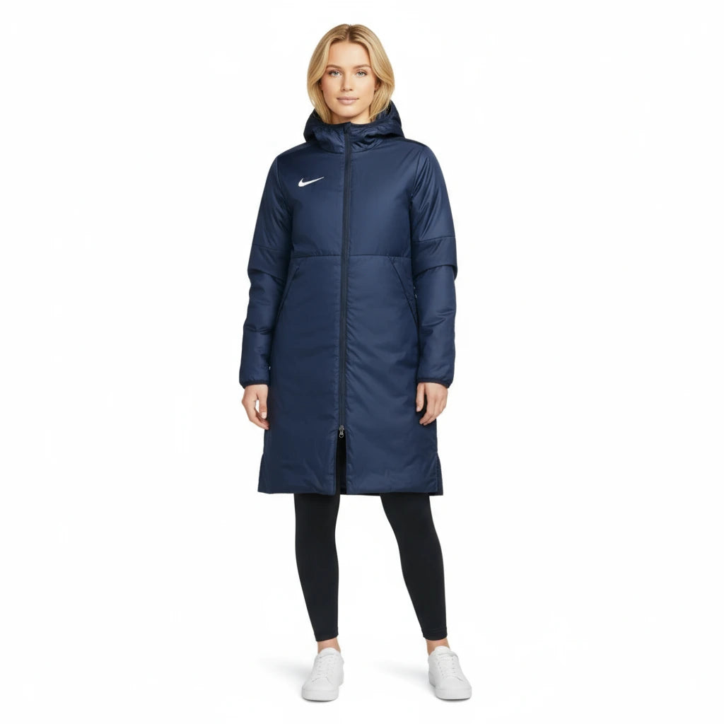 Woman wearing a blue Nike Park Stadium Jacket on a white background