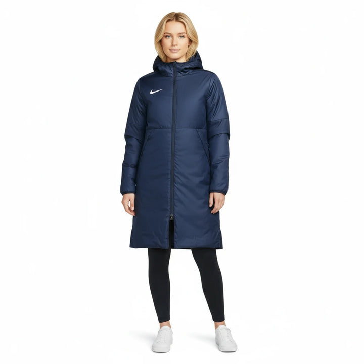 Woman wearing a blue Nike Park Stadium Jacket on a white background