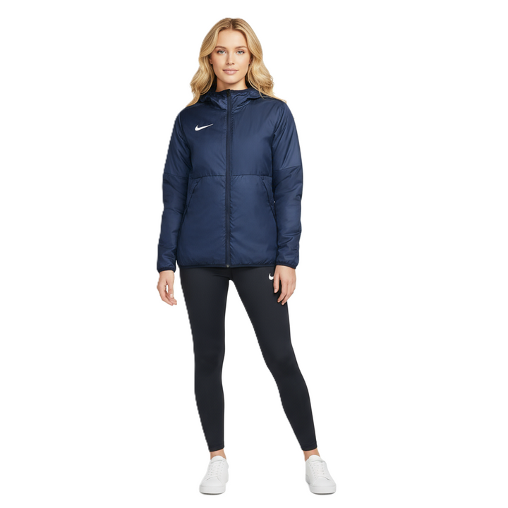 Woman wearing Nike Therma Repel Jacket in navy and black leggings on a white background