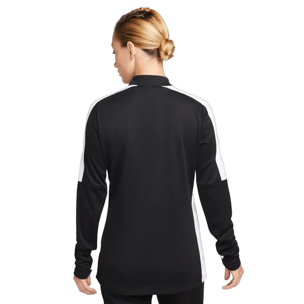 Rear view of woman wearing Nike black and white Academy Pro Jacket, full-length studio shot