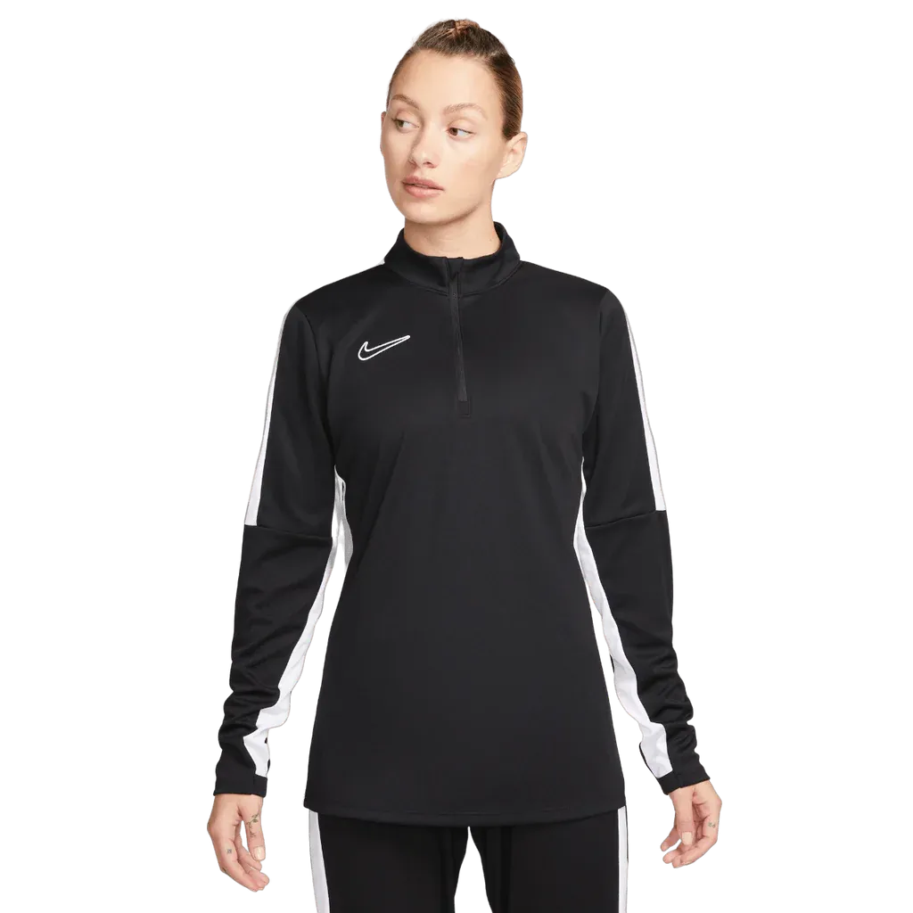 Woman in black Nike Academy Pro Jacket with white sleeve panels, standing straight