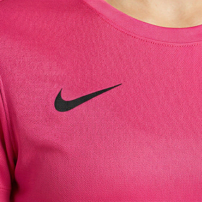 Pink long-sleeve shirt with black Nike logo on a person wearing it.