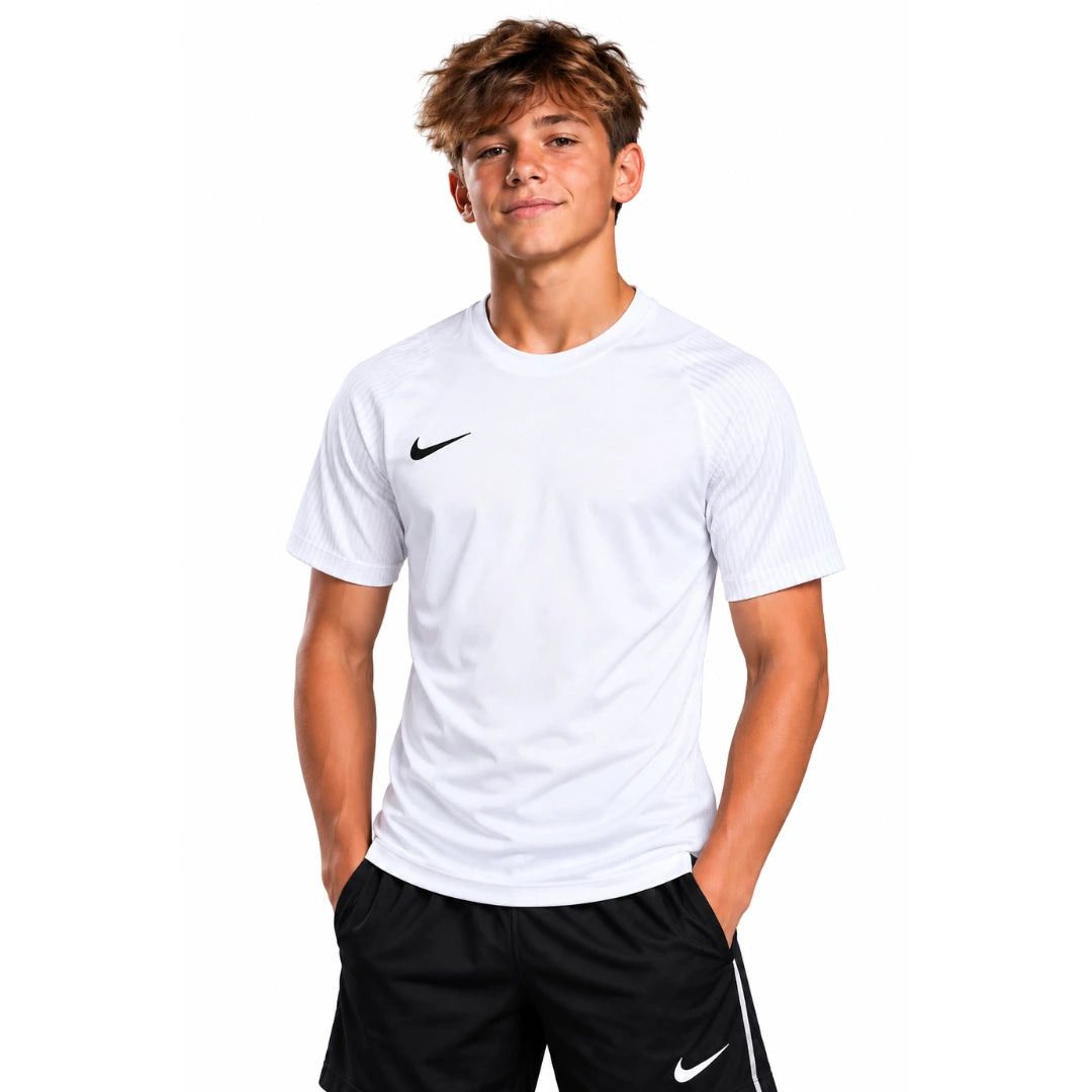 Youth player wearing the white Nike Academy 2 Youth Jersey with black Swoosh, front view