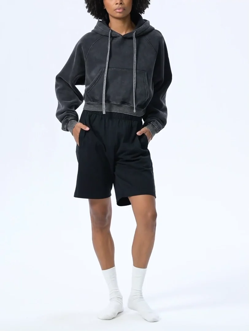 A female model wearing Empulse Snow washed cropped hoodie