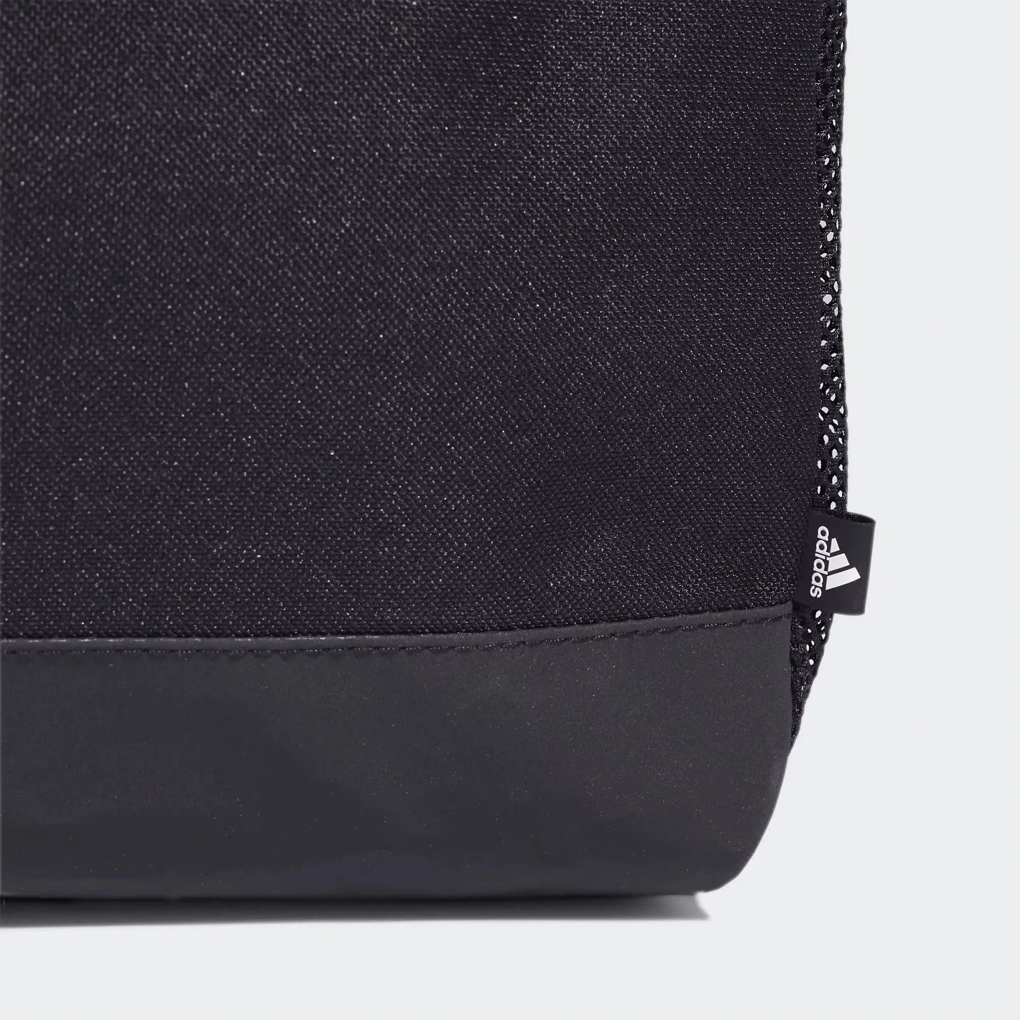 Close-up of Adidas Duffel Bag bottom corner showing textured fabric and reinforced base