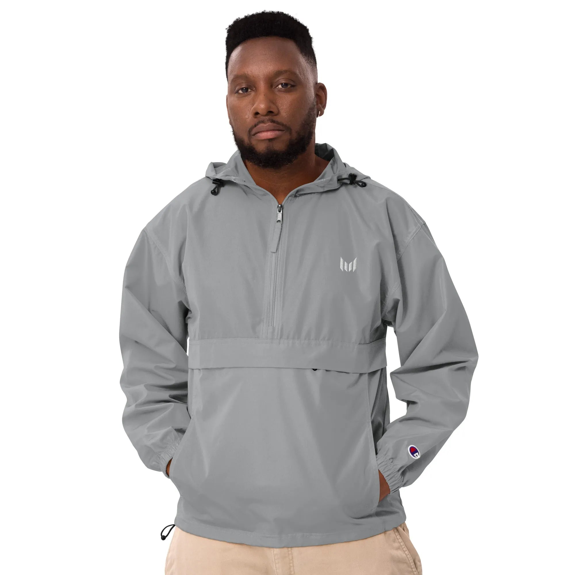 Light grey Empulse pullover windbreaker styled with beige pants