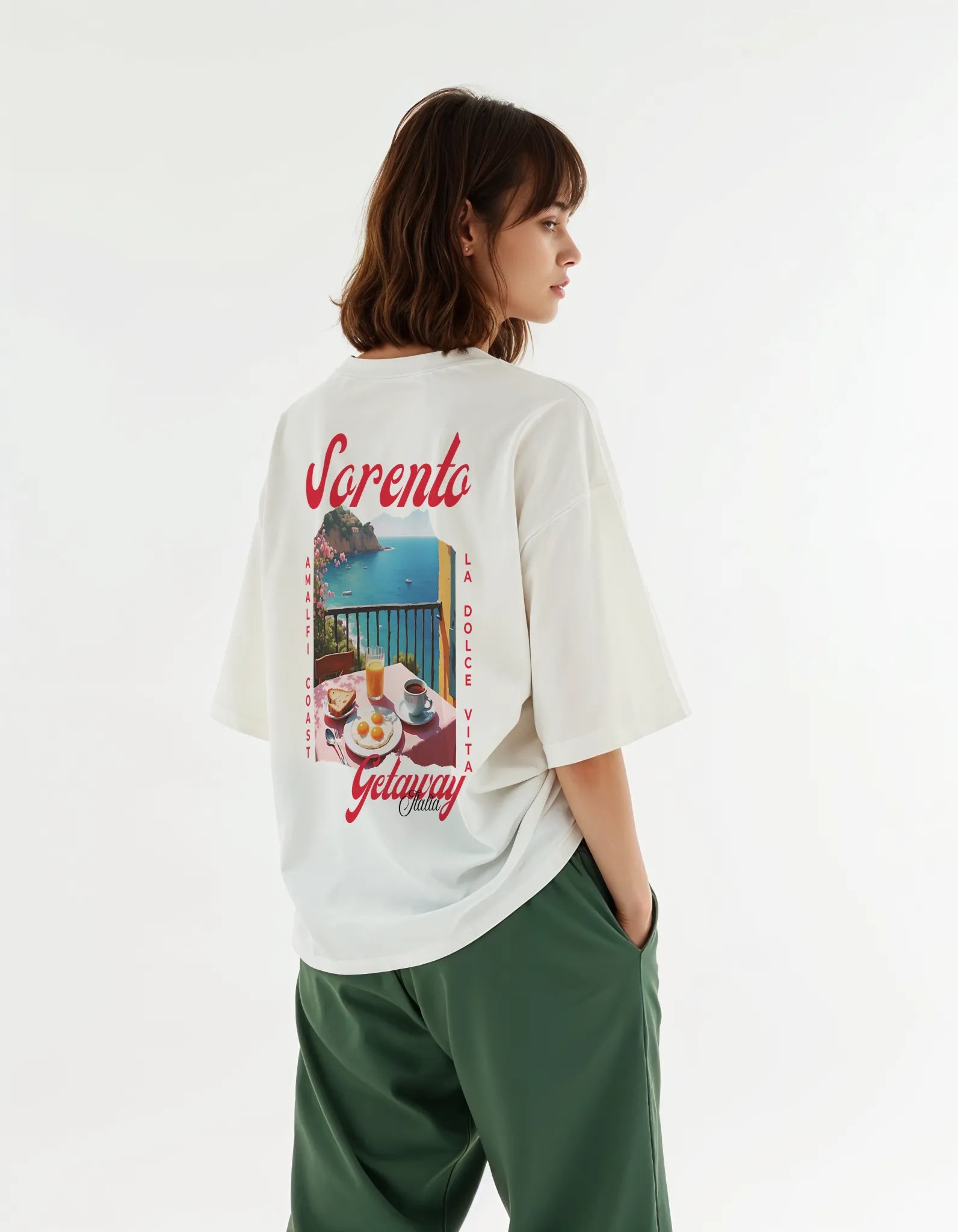 Empulse™ Amalfi Sorona t-shirt in white featuring scenic coastal postcard backprint, worn by female model