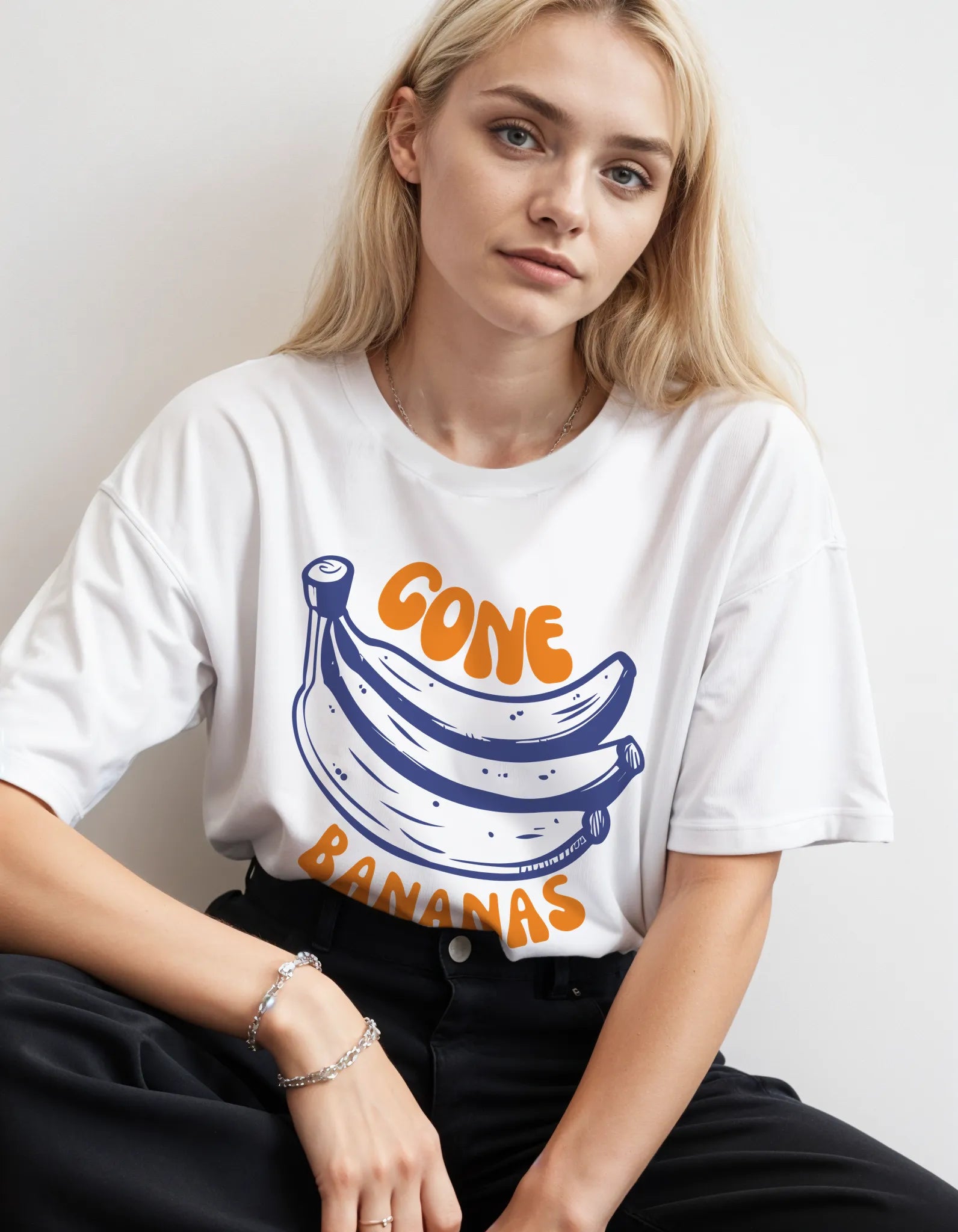 Empulse™ white Banana Sorona tee styled by female model in relaxed pose, seated side view