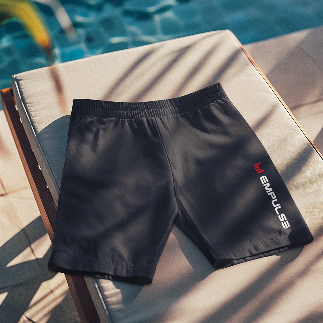 Empulse™ Blue swim shorts placed neatly on poolside lounge chair