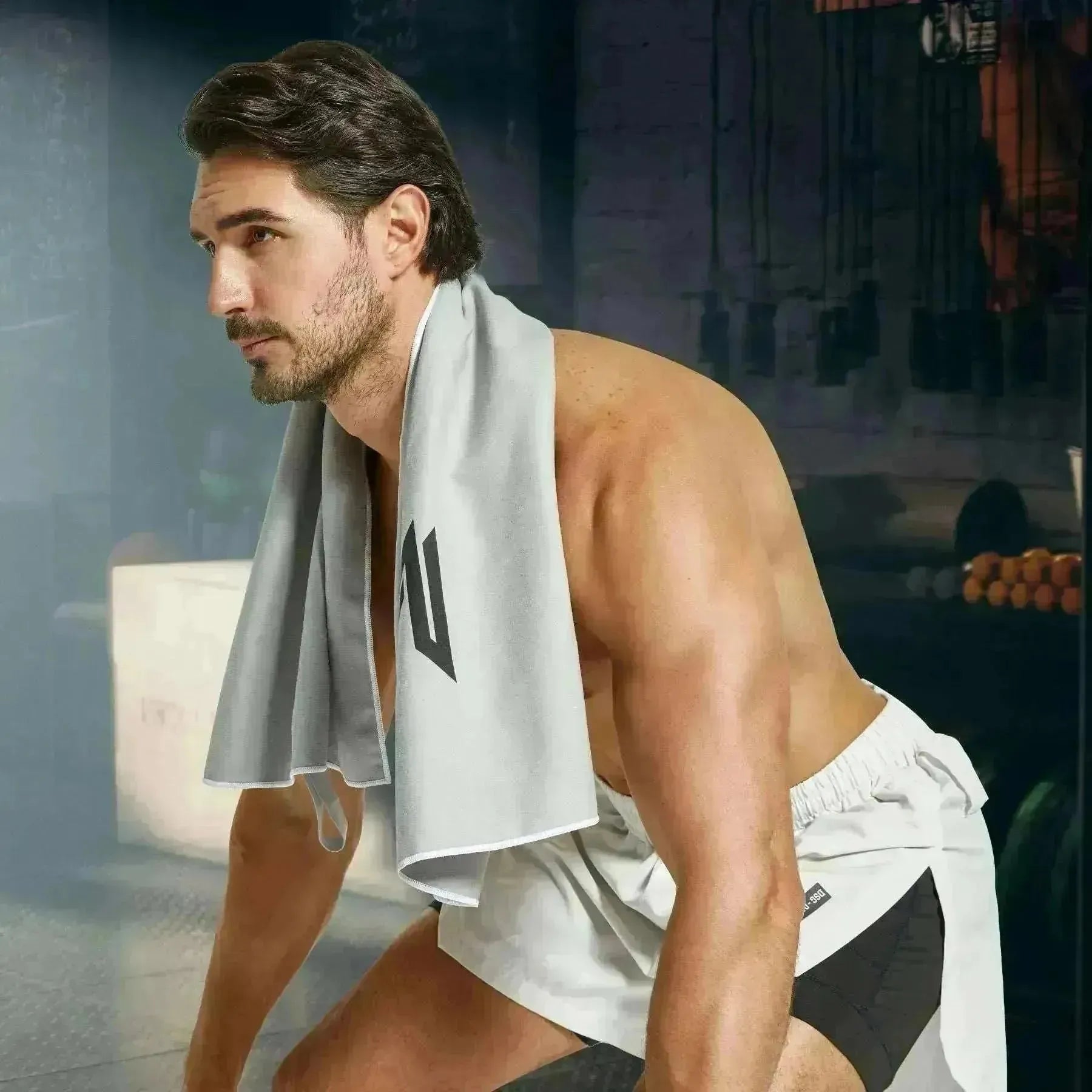 Model using Empulse™ Carbon Cool towel during late-night indoor training session